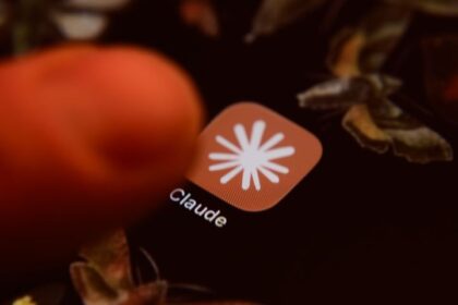 Claude app icon on a smartphone screen with mathematical formulas in the background